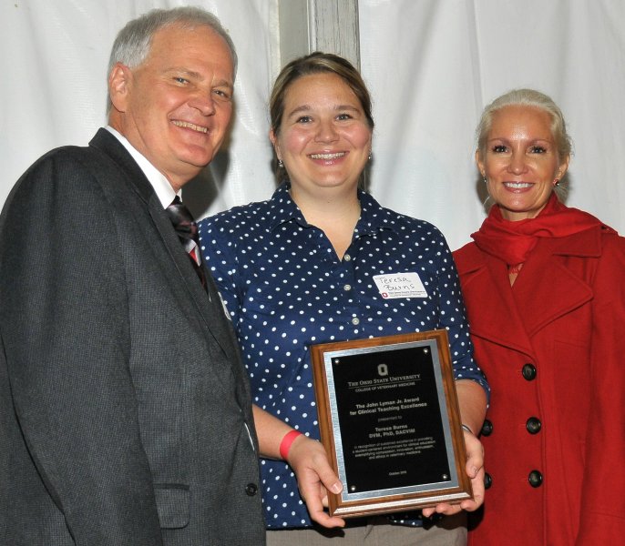 Dr. Teresa Burns (center) receives the John Lyman Jr. Award for Clinical Teaching Excellence.