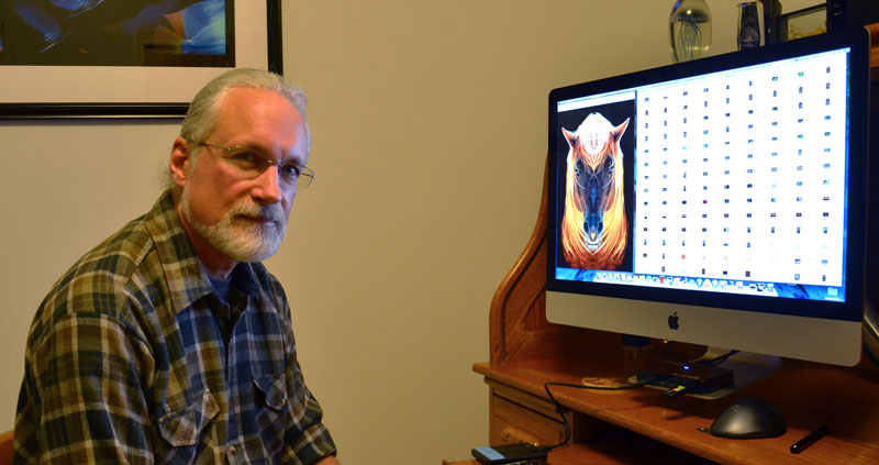 Ted Smusz works on a piece of digital art at a home studio. In some cases, Smusz spends up to 40 hours digitally remastering a single photo such as this one of a horse.