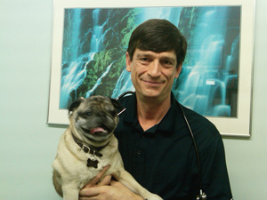 Dr. Palmquist poses with Bella, one of his patients.