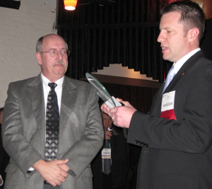 Dr. Johnston (right) presents Joe Cornely with the Friends of Veterinary Medicine Award.
