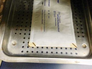 This single pouch is placed the correct way on an autoclave tray.
