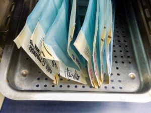 This photo illustrates the correct way to place pouches in an autoclave rack.