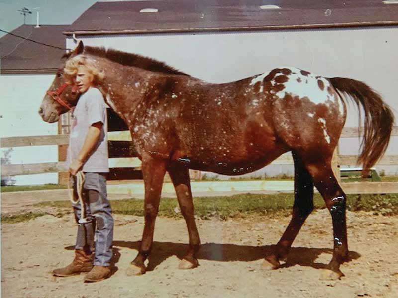 A 14-year-old Ostrum with his first horse, an Appaloosa mare, which he says set him to his path to veterinary medicine.