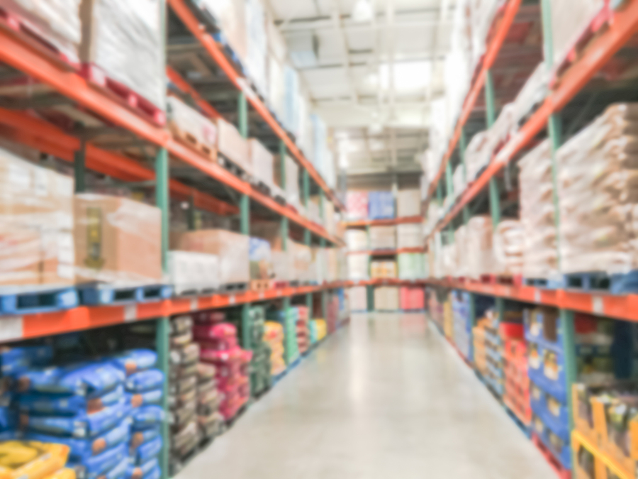 Blurred abstract dog and cat food shelves in modern distribution warehouse or storehouse. 