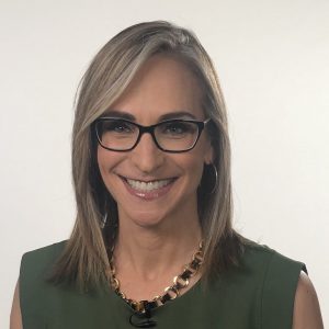 Smiling woman with glasses and necklace